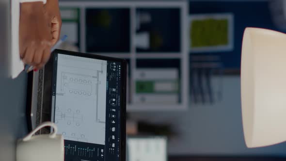 African Architect Analysing Digital Plans From Laptop alt