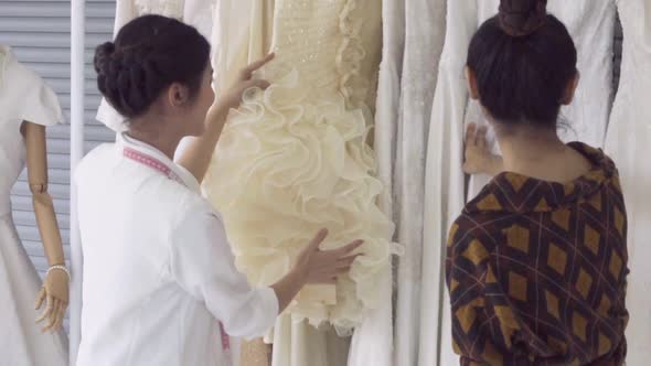 Future Bride Customer Talking with Wedding Store Shopkeeper alt