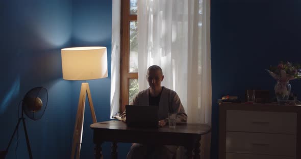 Caucasian Bald Girl Freelancer Working on Computer at Home alt