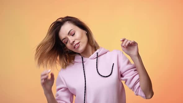 Woman in Casual Clothes Dancing on Color Background