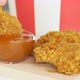 Man dunks fried chicken wing in sauce. Close-up. Slow motion. - VideoHive Item for Sale