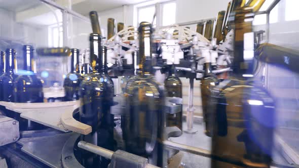 Close Up View of Wine Bottles Moving Along the Conveyor Belt alt