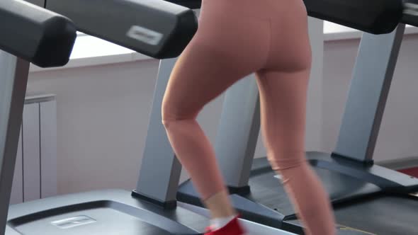 Young woman training on treadmill