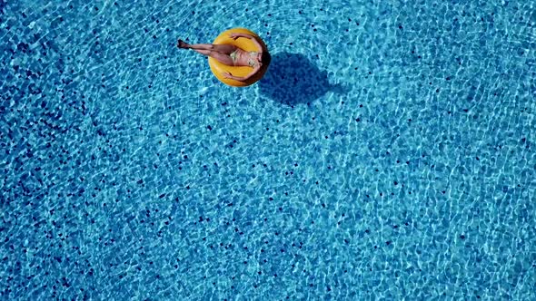 Top Scene To the Joyful Adult Girl Swim in Inflatable Ring Under Sunlight alt