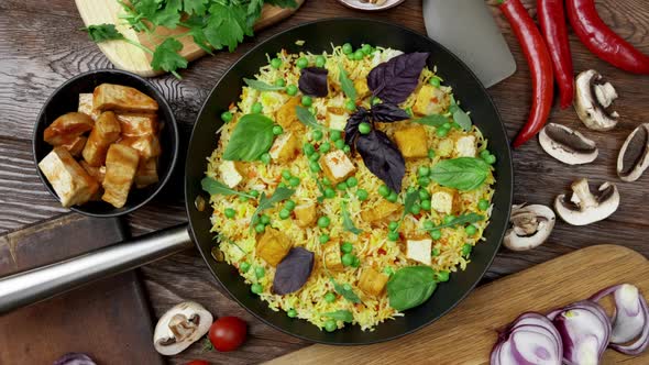 Vegetable Rice with Green Peas Carrots Tofu and Mushrooms on Wooden Background alt
