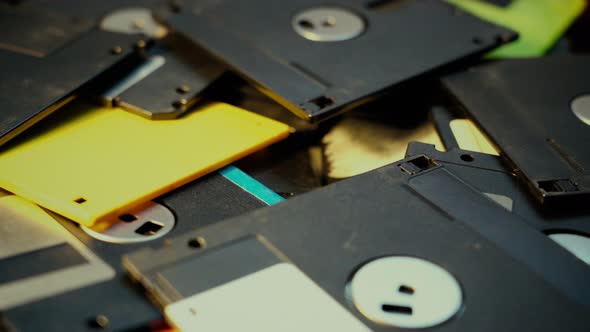 Old technolohy floppy discs falling into pile