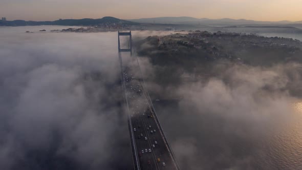 aerial hyperlapse video of Fatih Sultan Mehmet Bridge on a foggy day in Istanbul, Turkey. alt