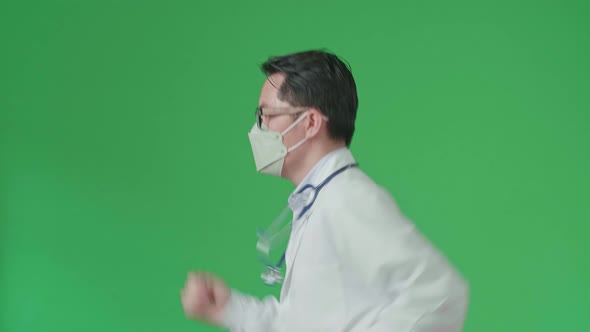 Asian Doctor With Stethoscope Wearing Mask, Running On Green Screen Chroma Key alt
