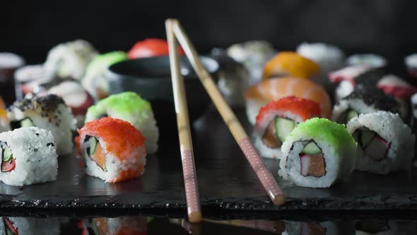 Healthy Japanese Meal with Fresh Fish, Vegetables and Rice on a Stone Board. alt