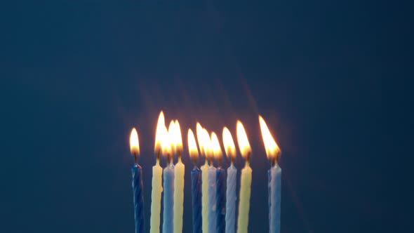 Some Candles on Blue Background Blown Off