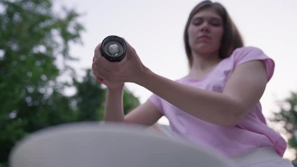 Female Hands Dressing Salad with Salt in Slow Motion Outdoors alt