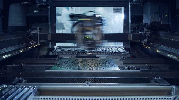 Surface Mount Technology SMT Machine places components on a circuit board alt