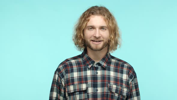 Slow Motion of Handsome Blonde Man with Beard and Long Curly Hairstyle Wearing Checked Shirt Saying
