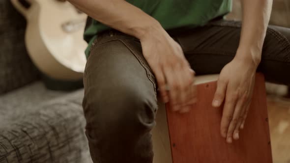 Crop Musician Playing Cajon at Home