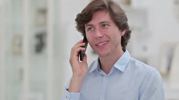 Portrait of Cheerful Young Businessman Talking on Smartphone alt