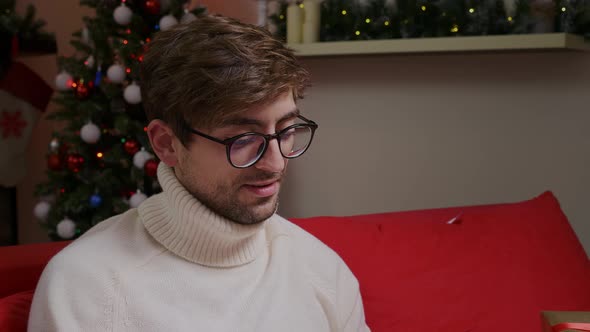 Close up man freelancer in eyeglasses looking at laptop screen, working remotely at home. alt