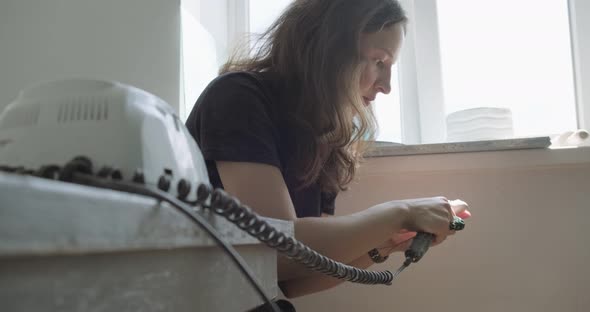 Woman Making Doll Ceramic Part. Female Sitting and Creating Ear for Doll at Home at Table. Pottery alt