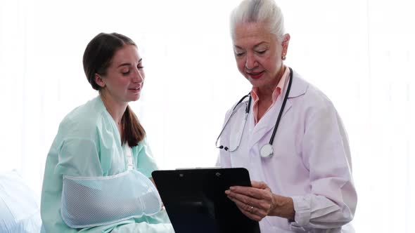 Senior Female doctor explaining the woman patient's results from sick symptoms alt