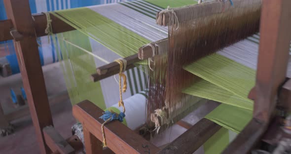 A Footage of a Woman Using Loom in a Traditional Asaian Factory