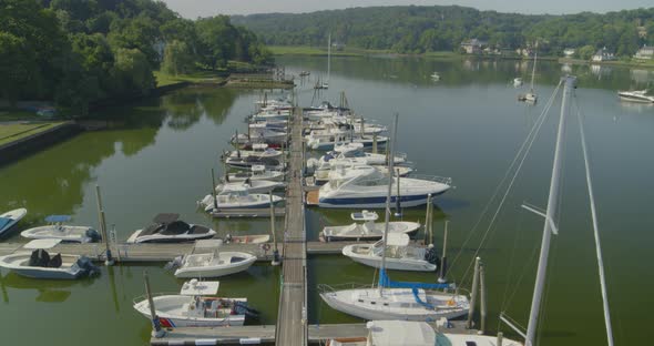 Aerial Tilt Down of Boats Docked at a Marina in Cold Spring Harbor Long Island alt