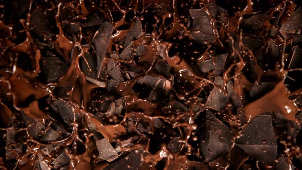 Super Slow Motion Shot of Melted Chocolate Explosion Through Chocolate Chunks at 1000 Fps alt