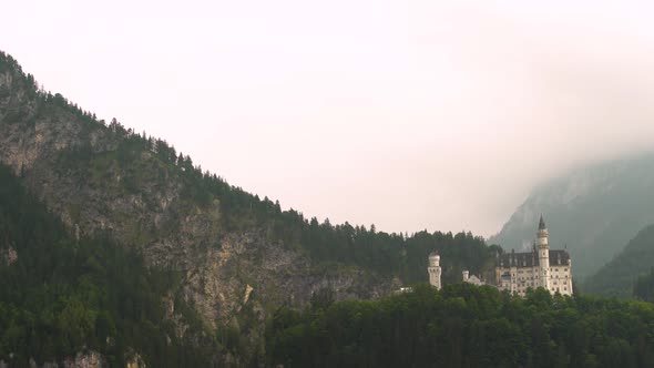 Neuschwanstein Castle in misty day, Bavaria in Germany. Zoom in alt