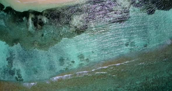 Tropical above clean view of a white sandy paradise beach and aqua blue water background in vibrant  alt