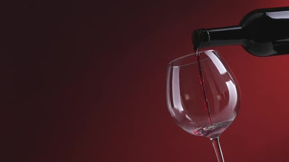 Red wine pouring into a glass