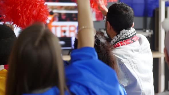 Fans with pom-poms cheering for team