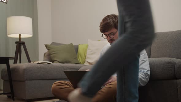 The Man Types Into the Computer and Looks Back at the Girl Passing By alt