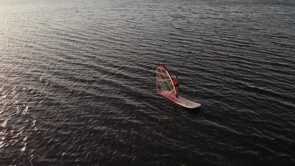 Aerial View of a Sportive Young Woman Learning to Fly a Windsurf Board alt