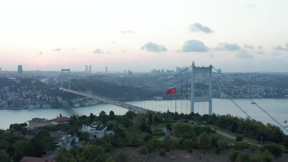Turkish Flag Waving in Wind in Front of Istanbul Bosphorus Bridge and City Skyline at Beautiful alt