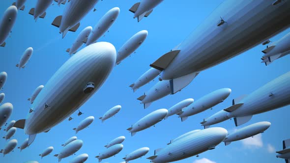 Large fleet of dirigibles. Airships are flying diagonally  across the frame. alt