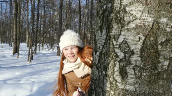 Happy Teenager Girl Playing In Winter Park, Kid Lets The Sunlight Spot alt