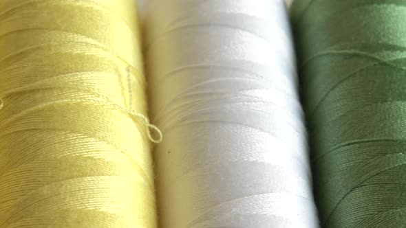 Top view of colorful thread spools isolated on white background alt