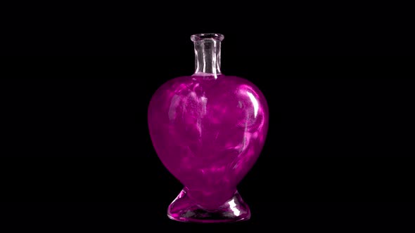 Glass Bottle in the Form of a Heart with Pink Liquid. The Elixir Is Spinning and Overflowing with alt