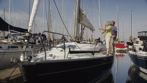 Senior couple on sailboat together. Shot on RED EPIC for high quality 4K, UHD, Ultra HD resolution. alt