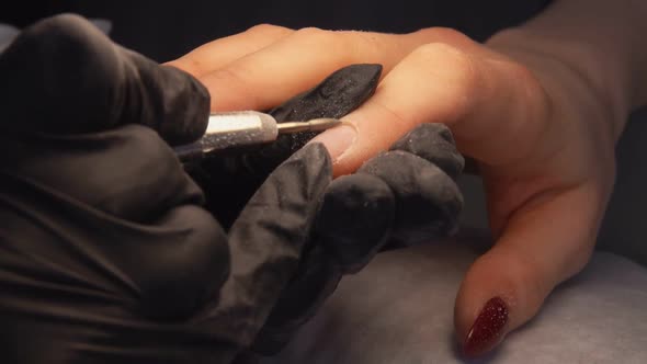 Manicurist Does the Processing of the Cuticle