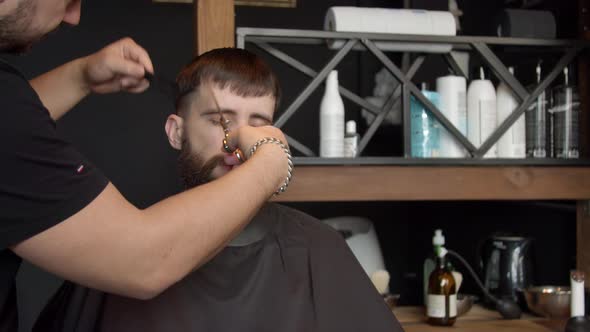 Barber Cutting Hair of Male Client