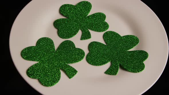 Rotating stock footage shot of St Patty's Day clovers on a white surface - ST PATTYS 004 alt