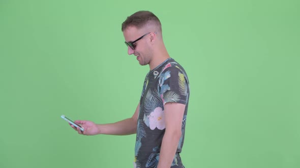 Happy Handsome Man Wearing Sunglasses with Phone Being Taken Away alt