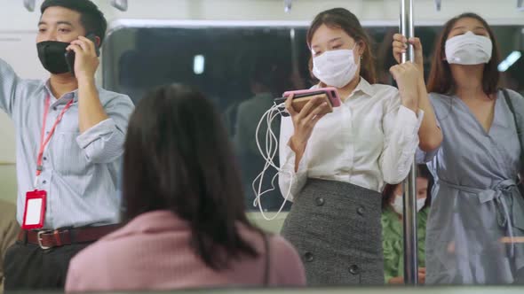 Crowd of People Wearing Face Mask on a Crowded Public Subway Train Travel alt