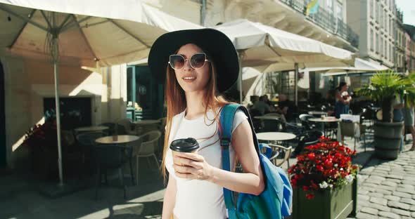 Tourist Girl with Coffee Smiling