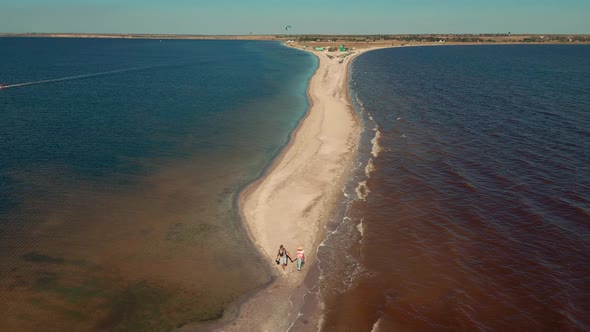 Aerial View Tourist Couple Walking By Sand Bar of Tiligul Landscape Park Mykolaiv Region alt