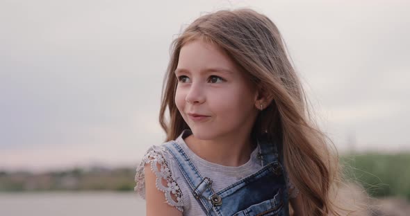 Little Girl Looking Amazedly on the Sky alt