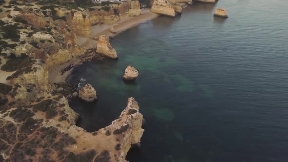 Stunning panorama of cliffs of Marinha beach in Algarve, aerial shot alt