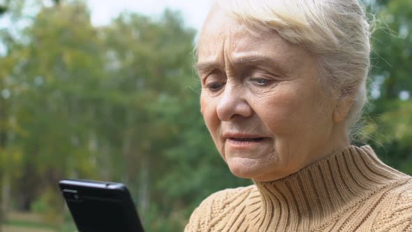 Concentrated Senior Woman Typing Smartphone Message Outdoors, Online Connection