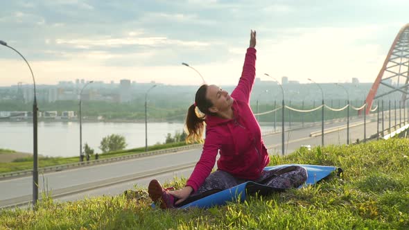 Sporty Woman Doing Stretching Exercise Outdoors alt