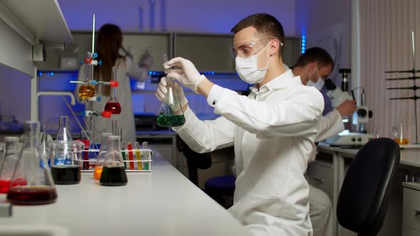 Young Scientist Mixing Colored Liquids