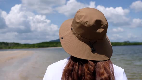 Blurred rear view of a woman looking at the sea